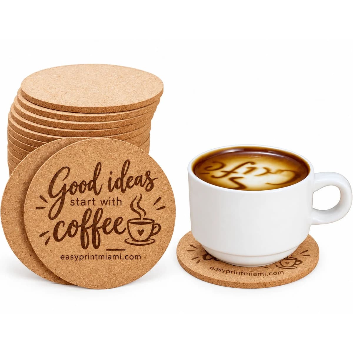 Laser engraved cork coaster with coffee business messaging beside a coffee cup
