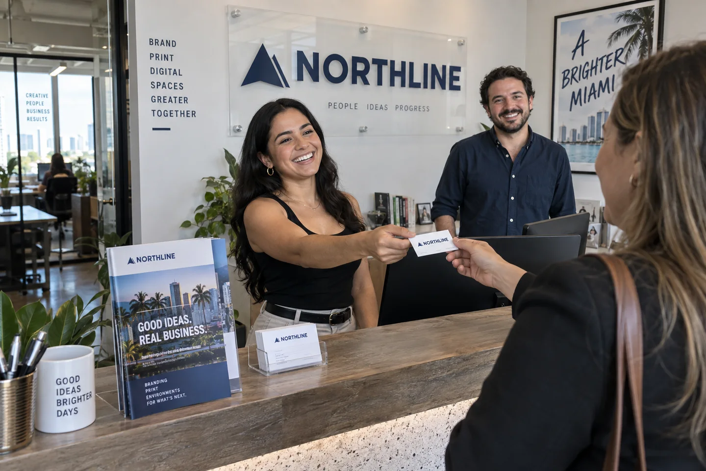 Northline team handing a branded business card to a visitor at reception